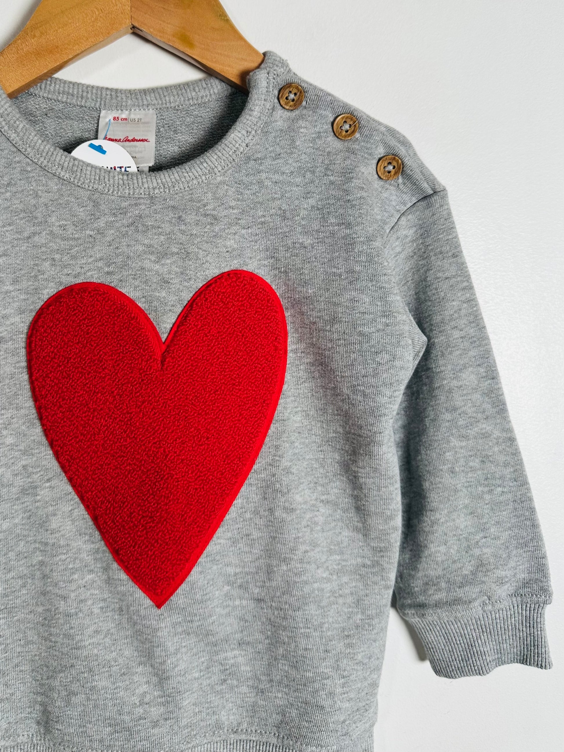 Gray sweater with a red heart on a white background