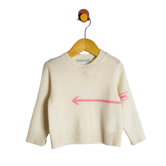 Beige sweater with a pink arrow design on a hanger against a white background