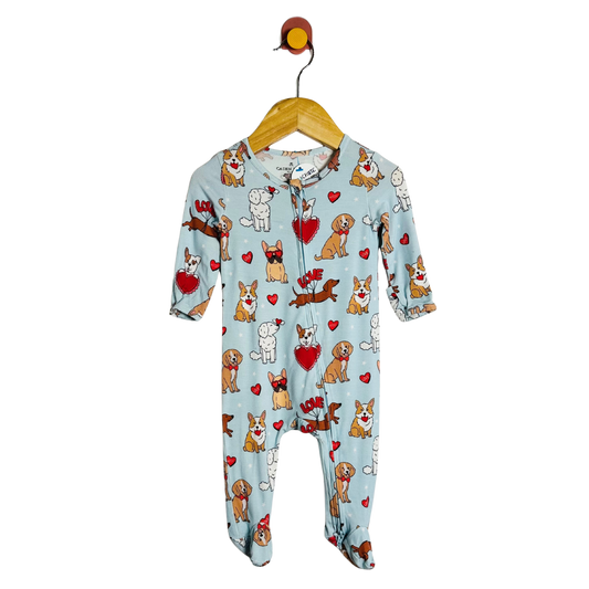 Baby onesie with dog pattern on a hanger against a white background