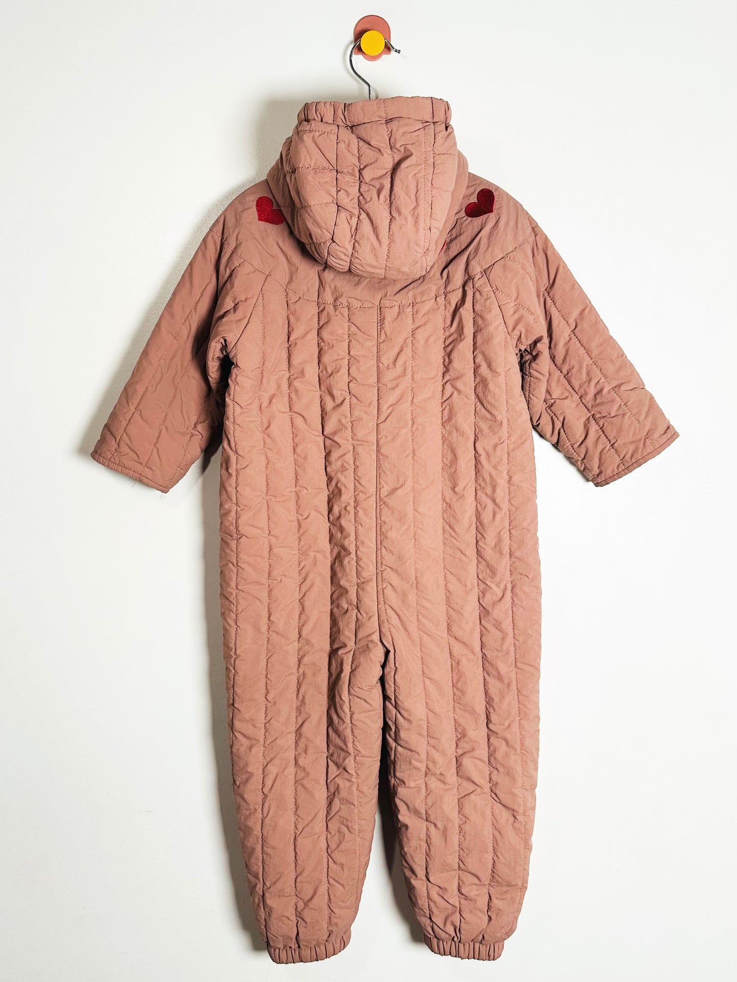 Quilted pink snowsuit on a white background