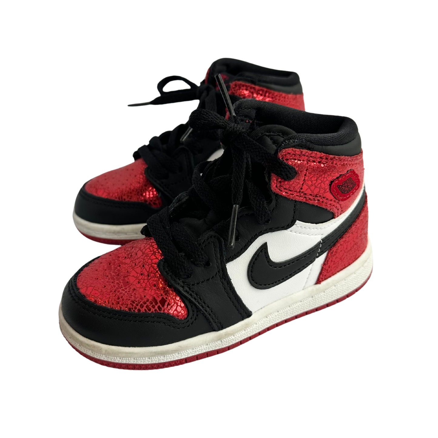 Red and black sneakers with a white logo on a white background