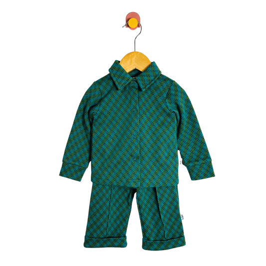 Green patterned children's outfit on a  hanger against a white background