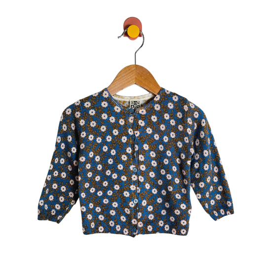 Floral-patterned shirt on a hanger against a white background