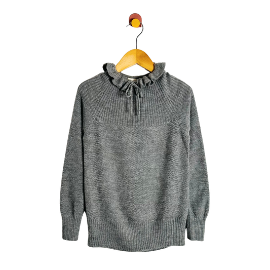 Gray sweater on a wooden hanger against a white background