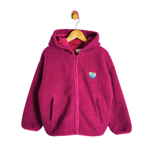 A bright pink fleece zip-up hoodie with a hood and front pockets, hanging on a wooden hanger against a plain white background.