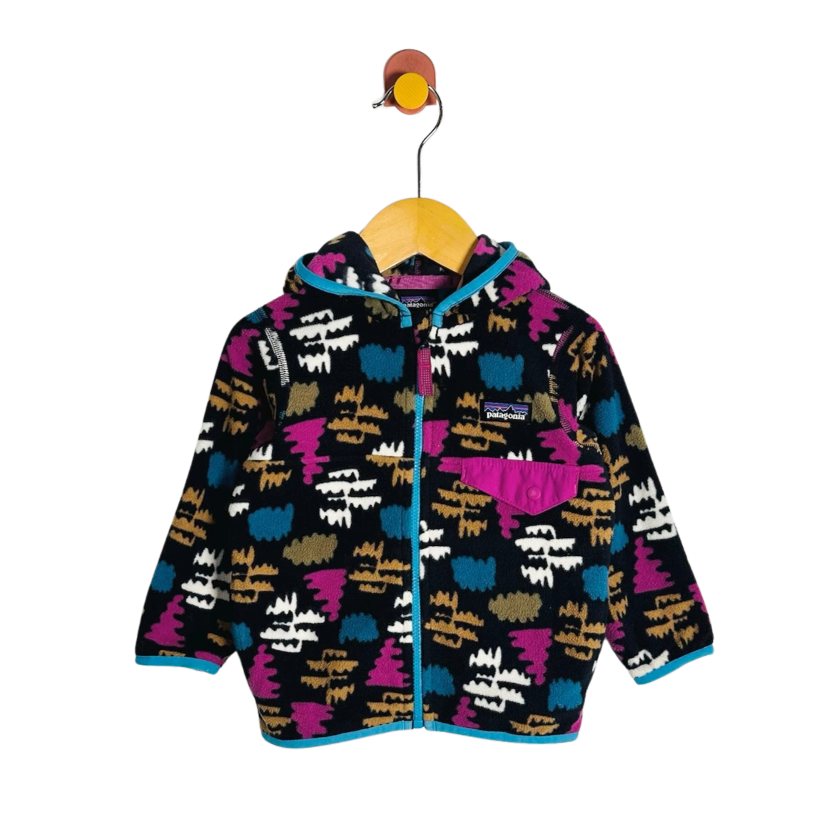 A children's hooded zip-up fleece jacket with a colorful abstract pattern, hanging on a wooden hanger against a plain white background.