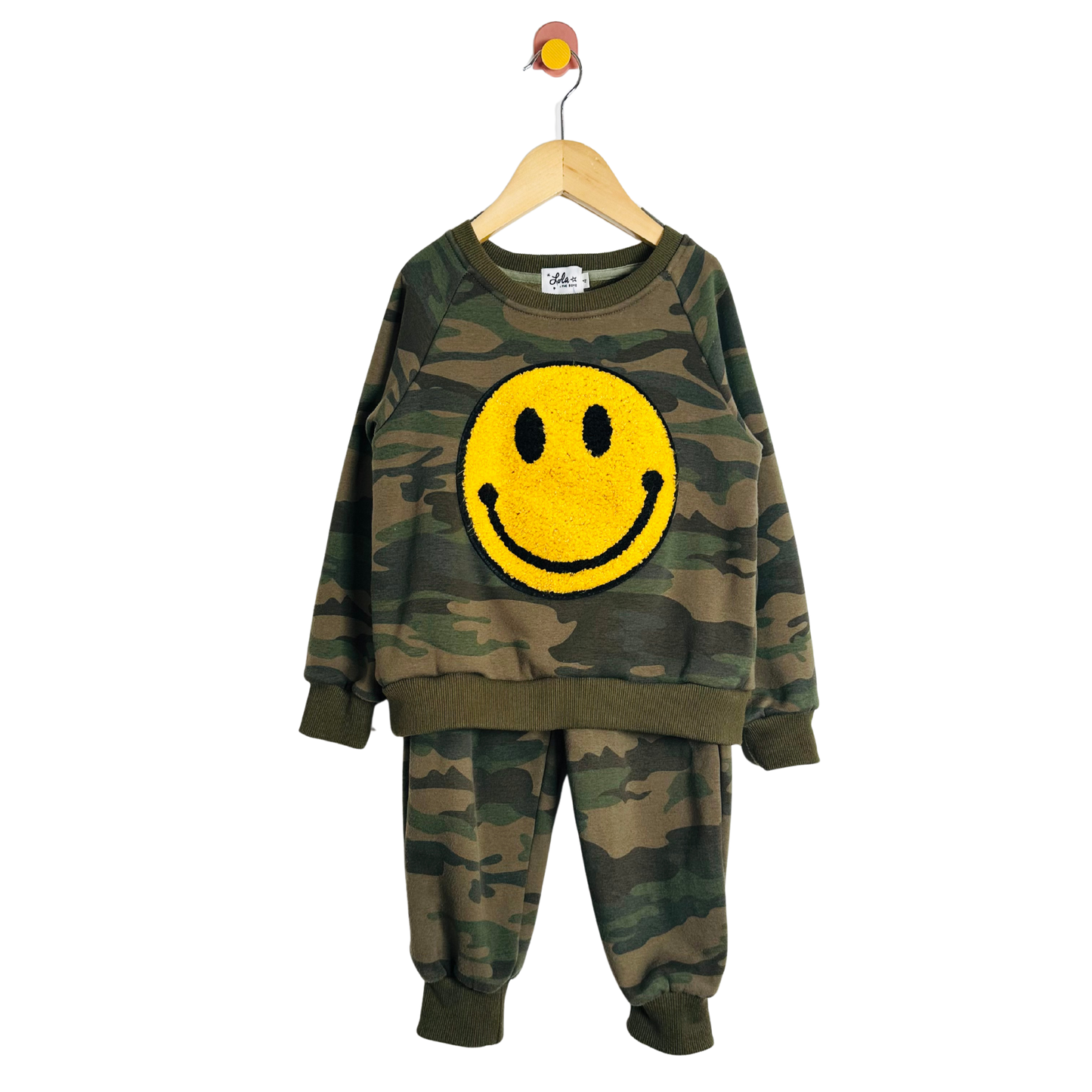 Camouflage children's outfit with a yellow smiley face on a white background