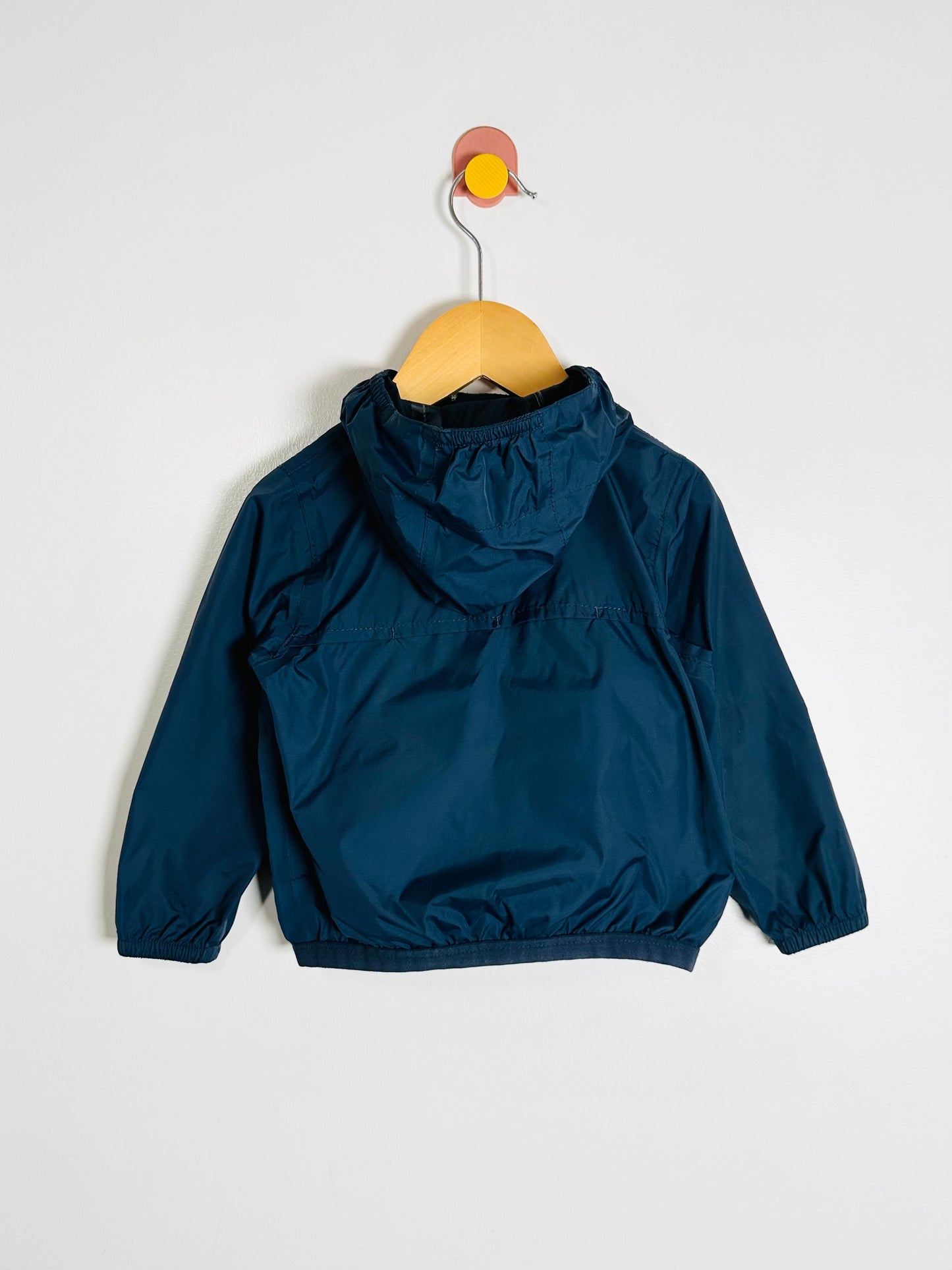 Blue jacket on a hanger against a white background