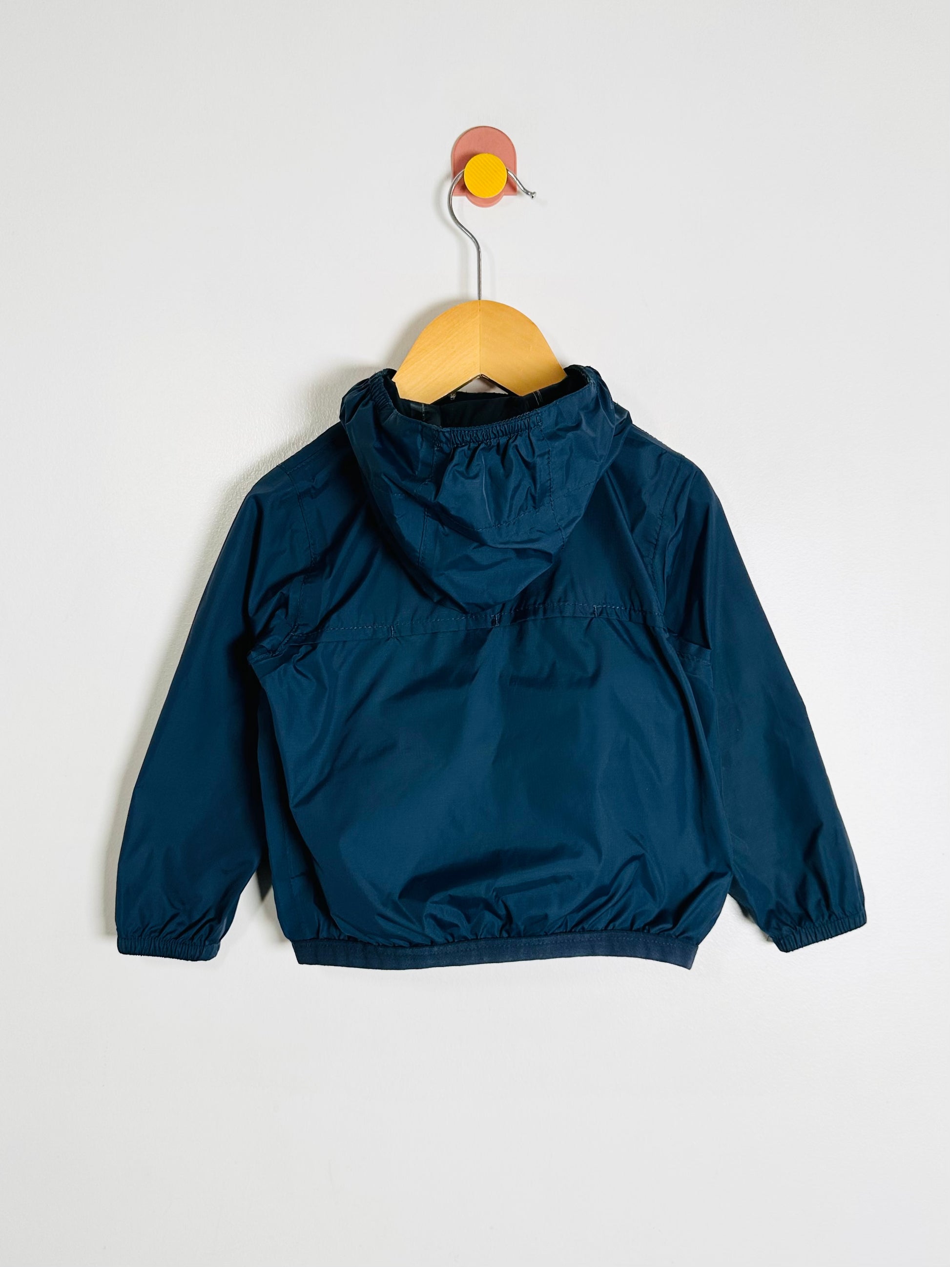 Blue jacket on a hanger against a white background