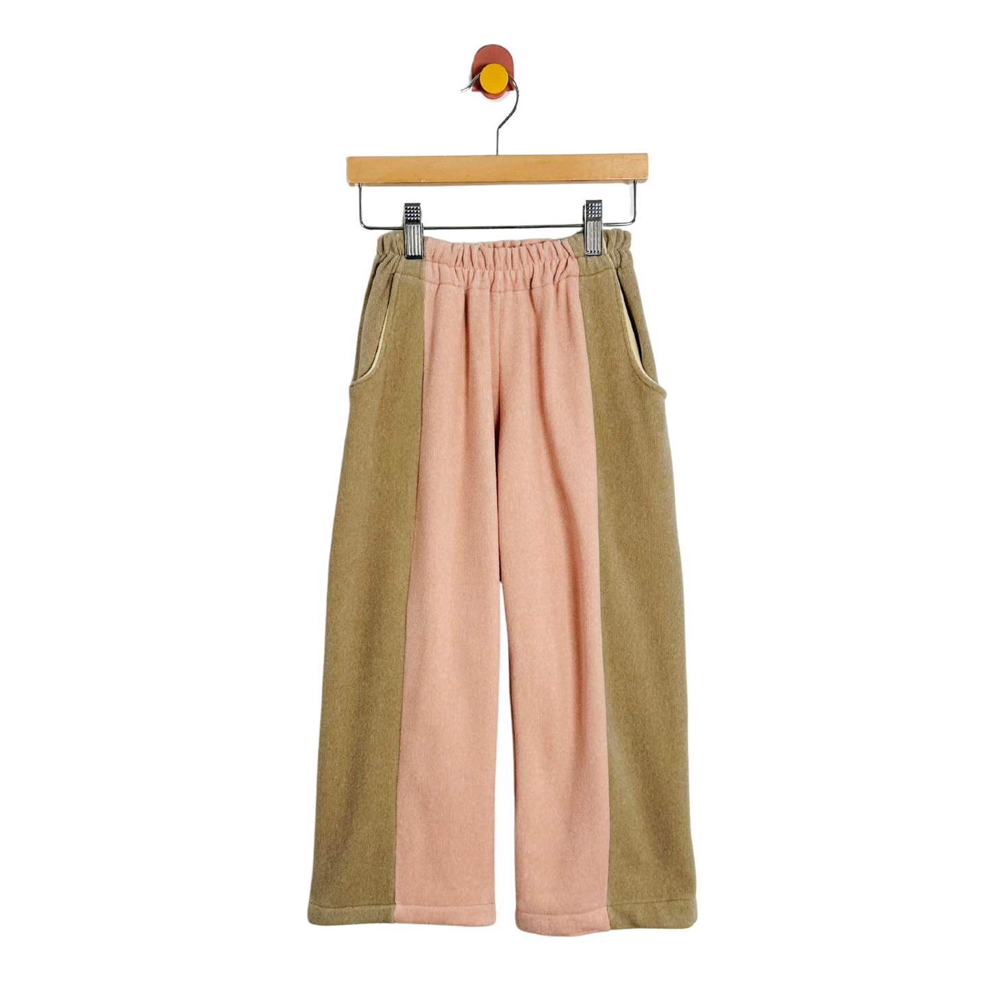 Two-tone pants on a hanger against a white background