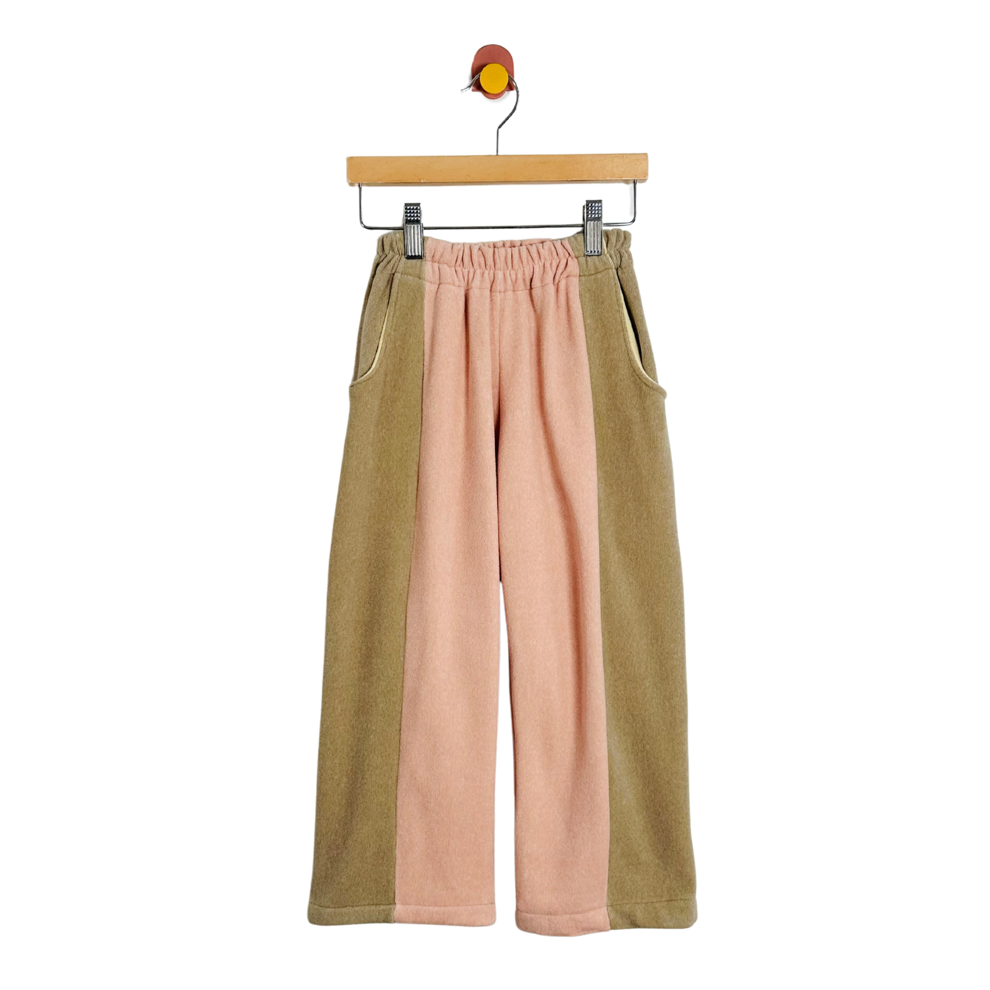 Two-tone pants on a hanger against a white background