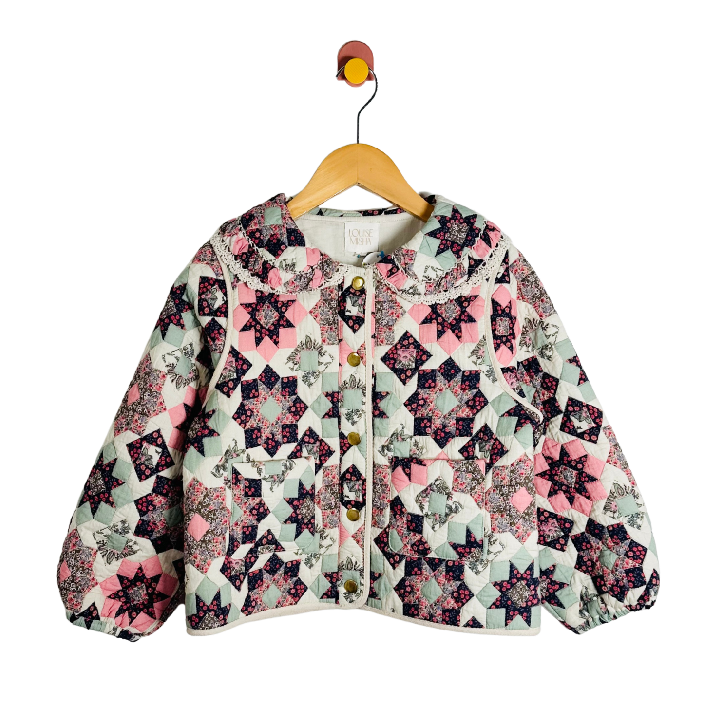 Floral patterned jacket on a hanger against a white background