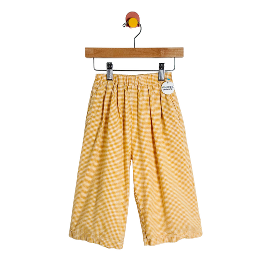 Yellow checkered pants on a hanger with a white background