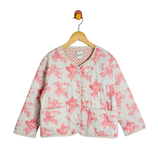 Floral-patterned jacket on a hanger against a white background