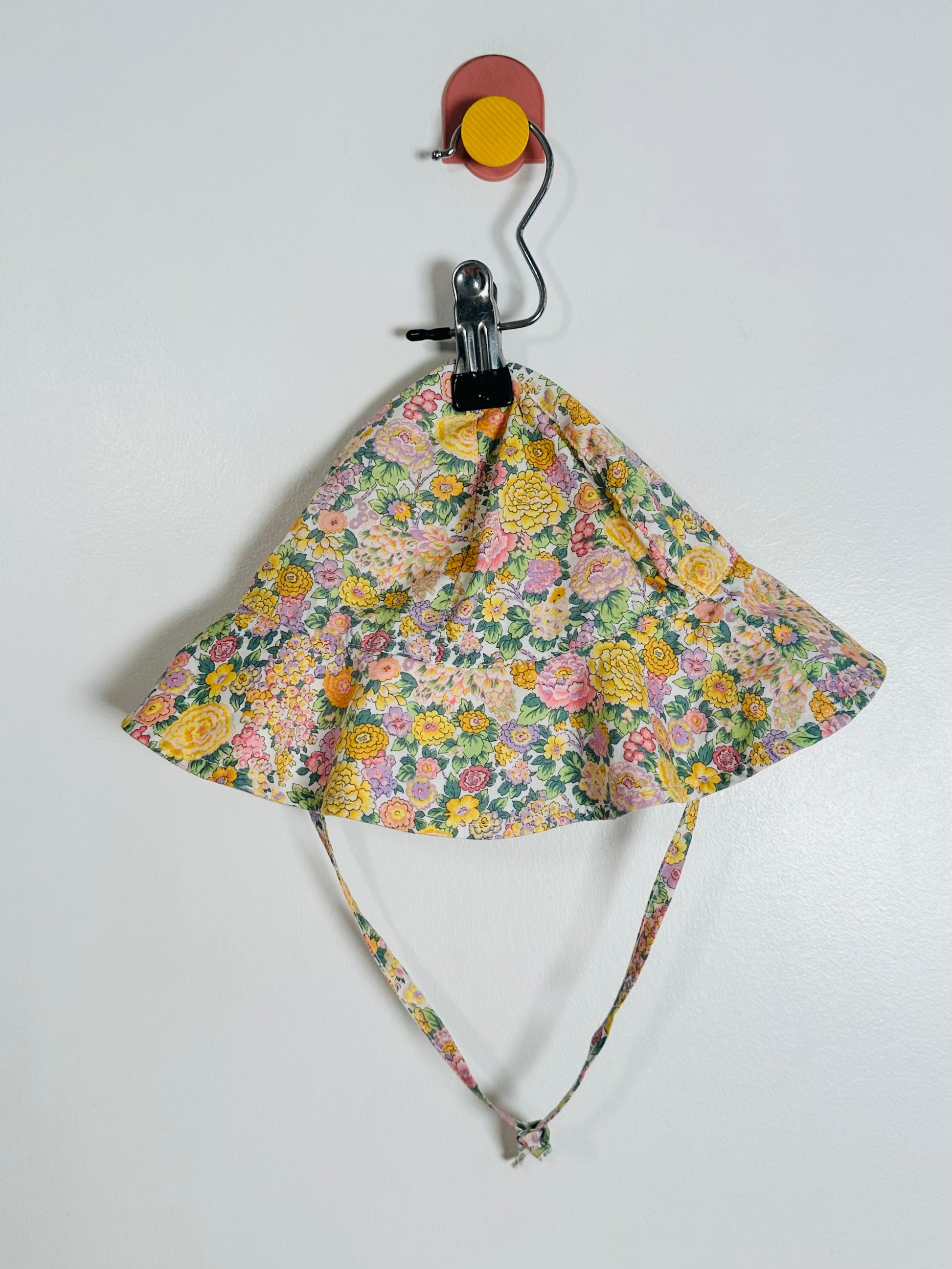 Floral patterned sun hat on a white background