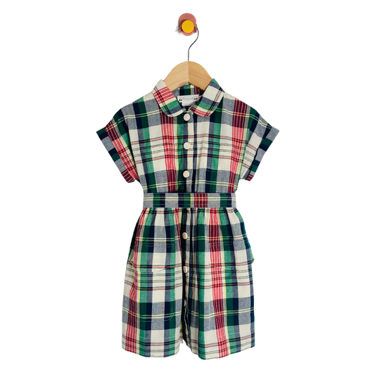 Plaid romper on a wooden hanger against a white background