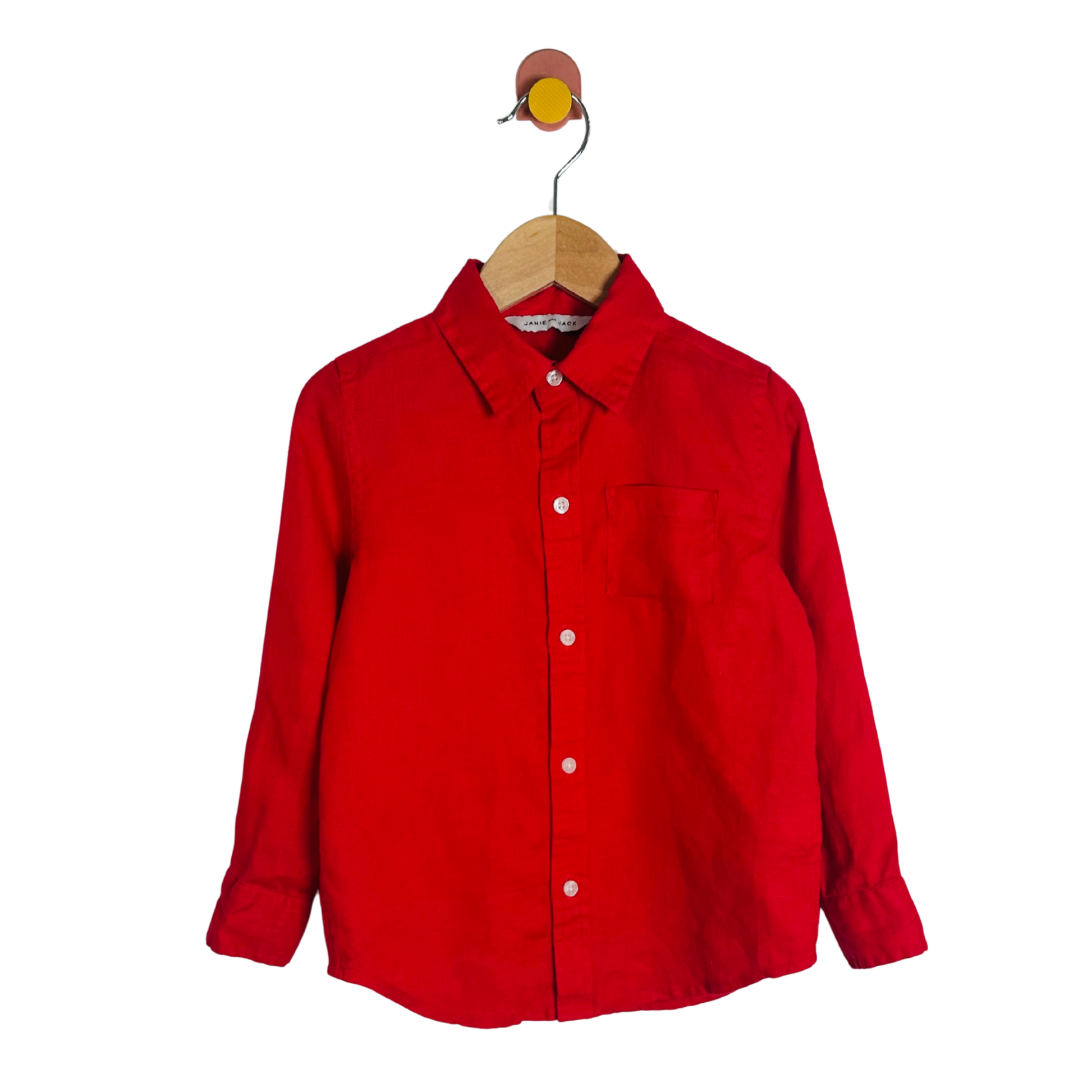 Red shirt on a wooden hanger against a white background