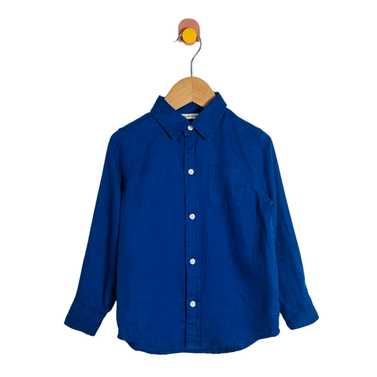 Blue shirt on a wooden hanger against a white background