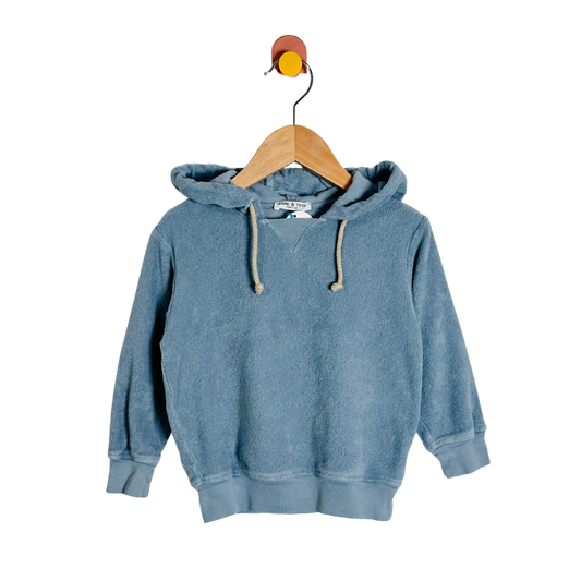 Blue hoodie on a wooden hanger against a white background