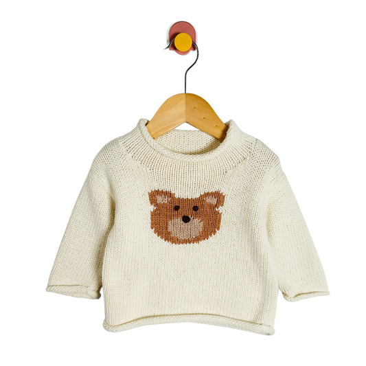 Baby sweater with bear design on a hanger against a white background
