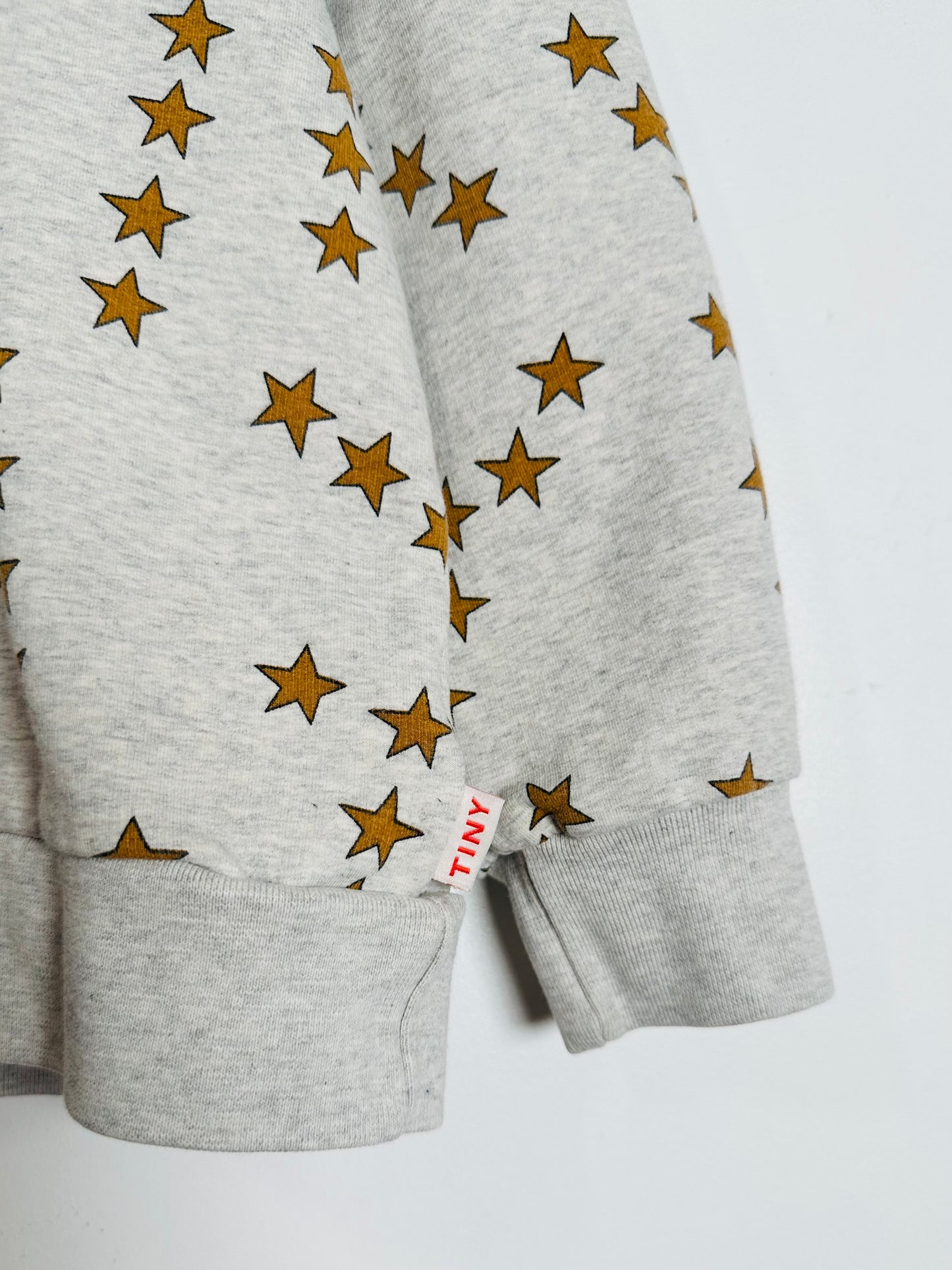 Gray sweatshirt with star patterns on a white background