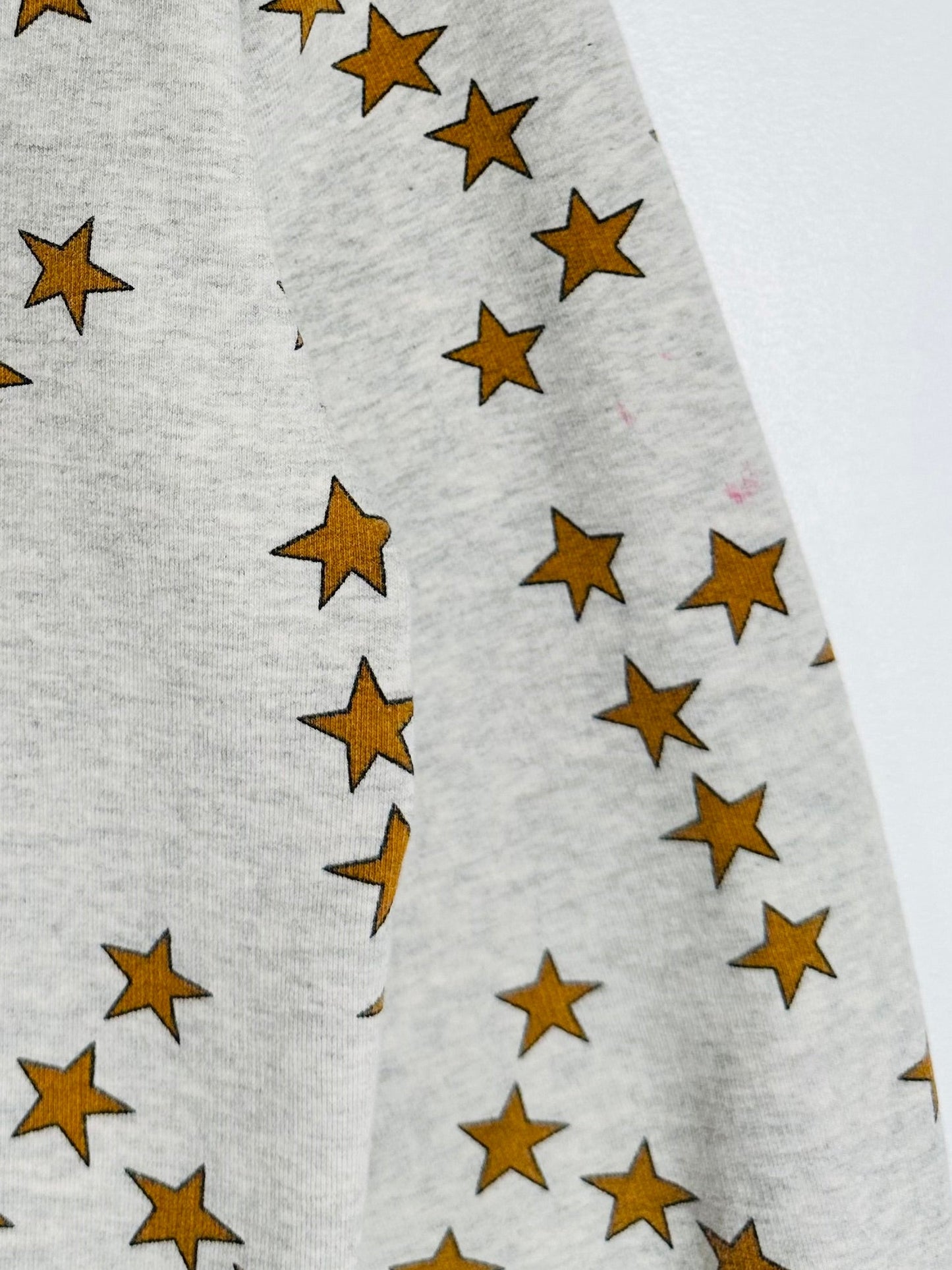 Gray fabric with gold star pattern on a white background