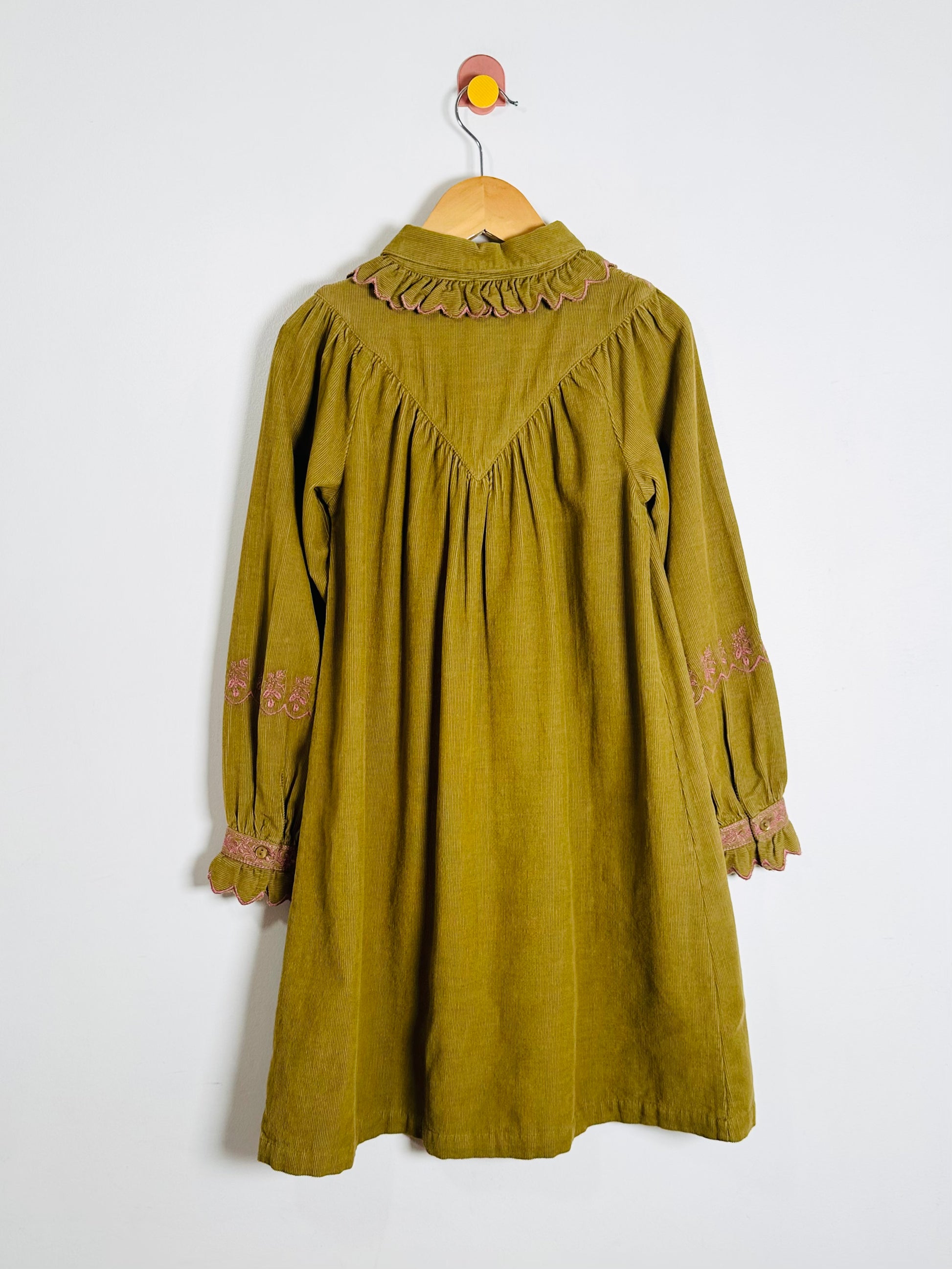 Green dress with lace details on a white background