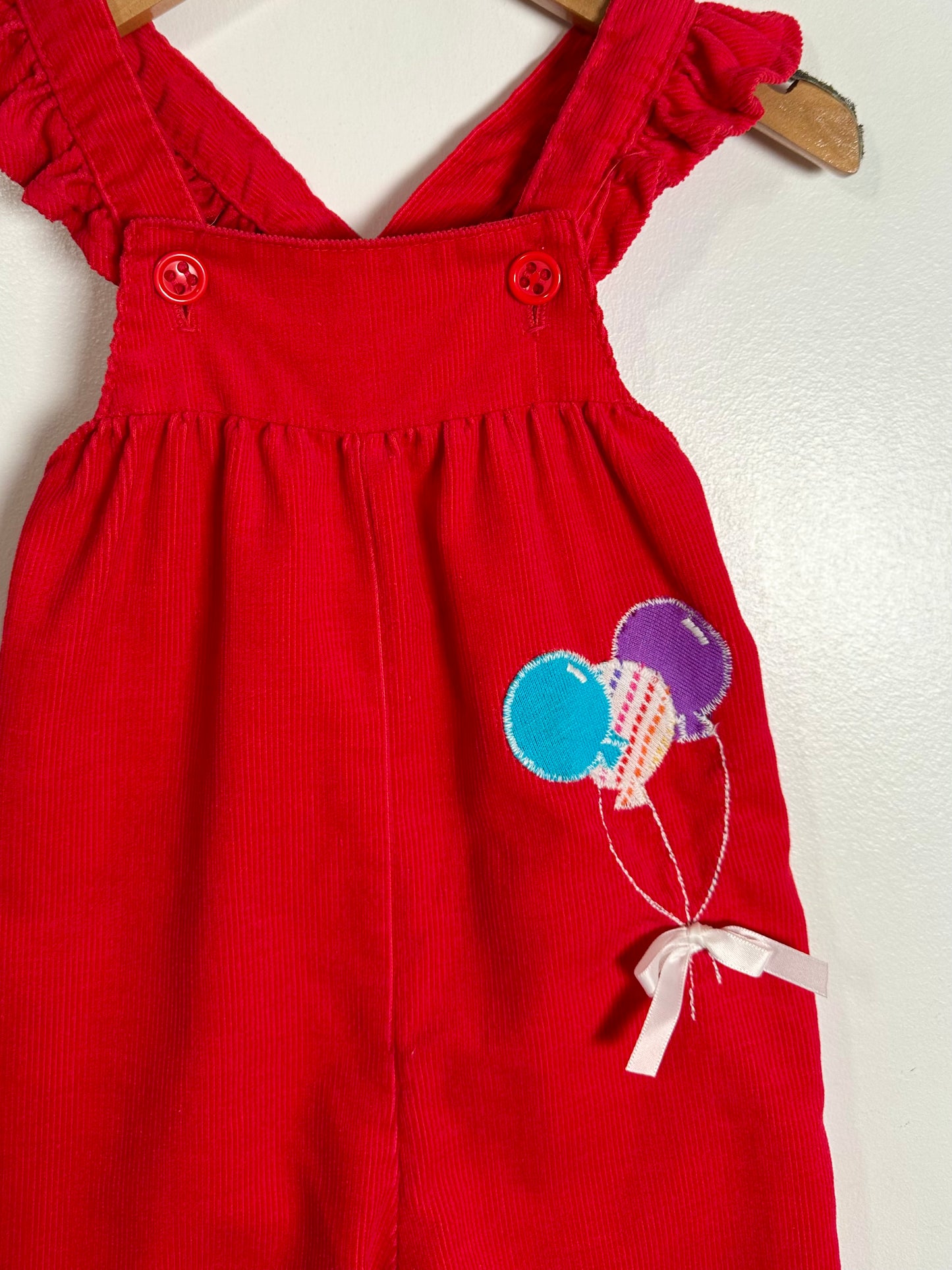 Red dress with balloon design on a white background