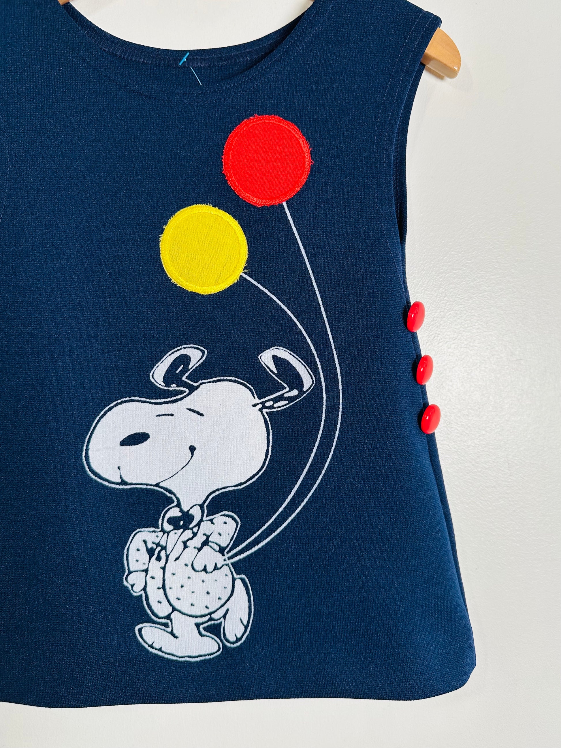 Navy blue sleeveless dress with cartoon character and balloons on a white background