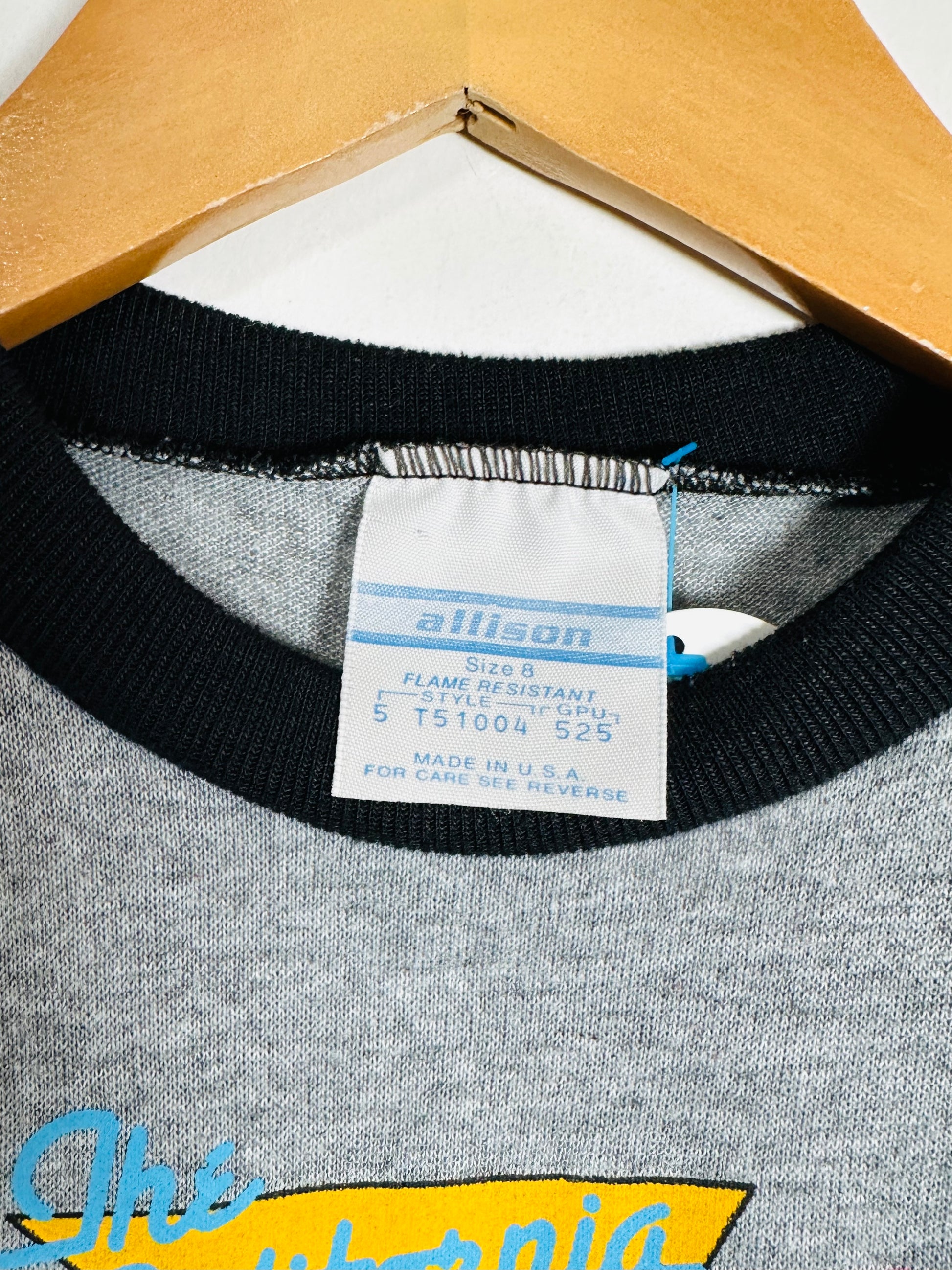 Gray sweatshirt with black trim and a visible label on a white background