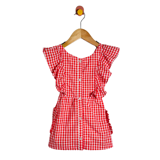 Red and white checkered dress on a wooden hanger against a white background