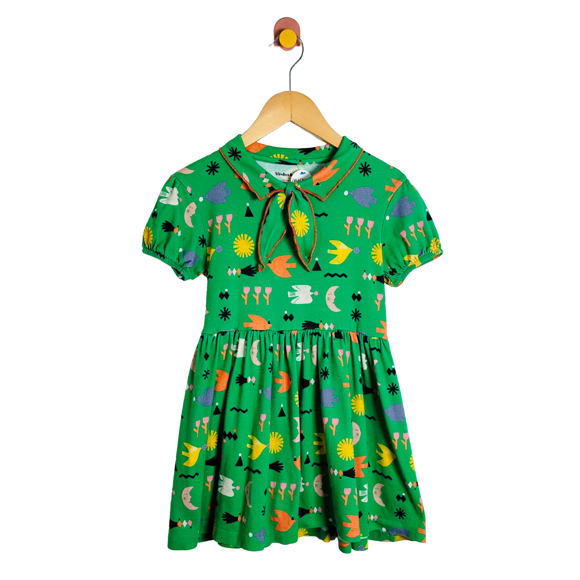 Green children's dress with colorful patterns on a hanger against a white background
