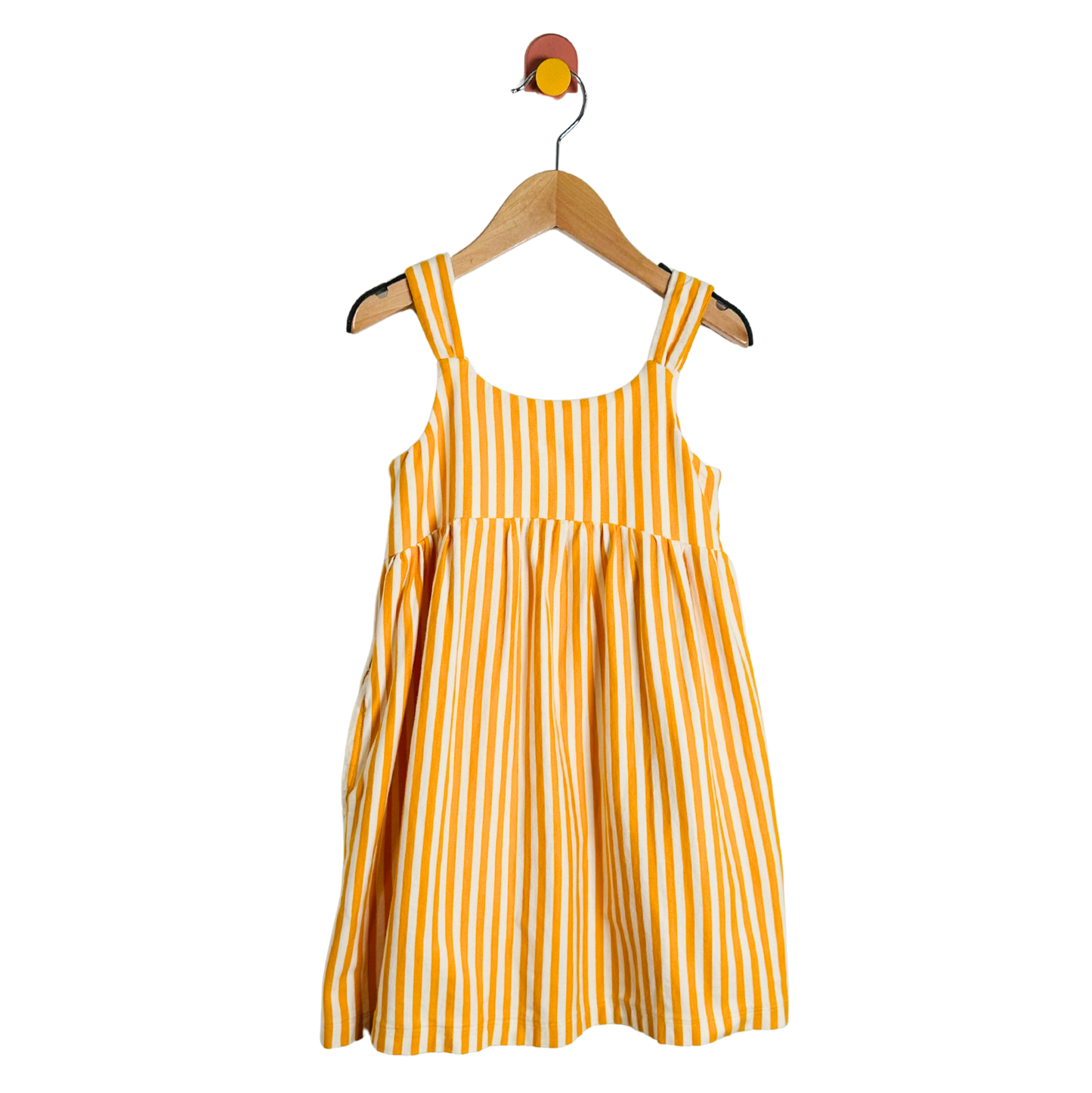 Yellow and white striped dress on a hanger against a white background