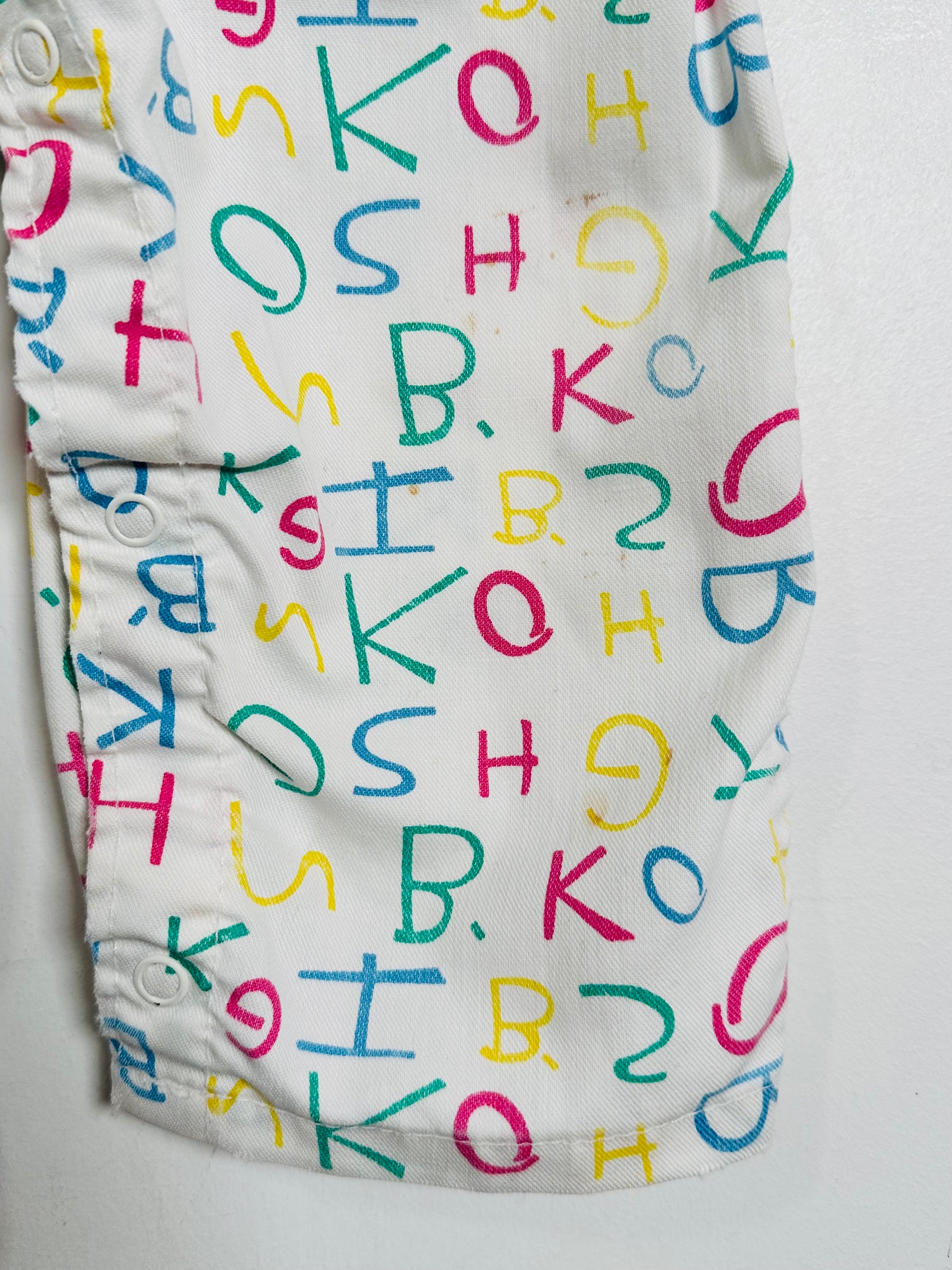 White fabric with colorful letters on a white background