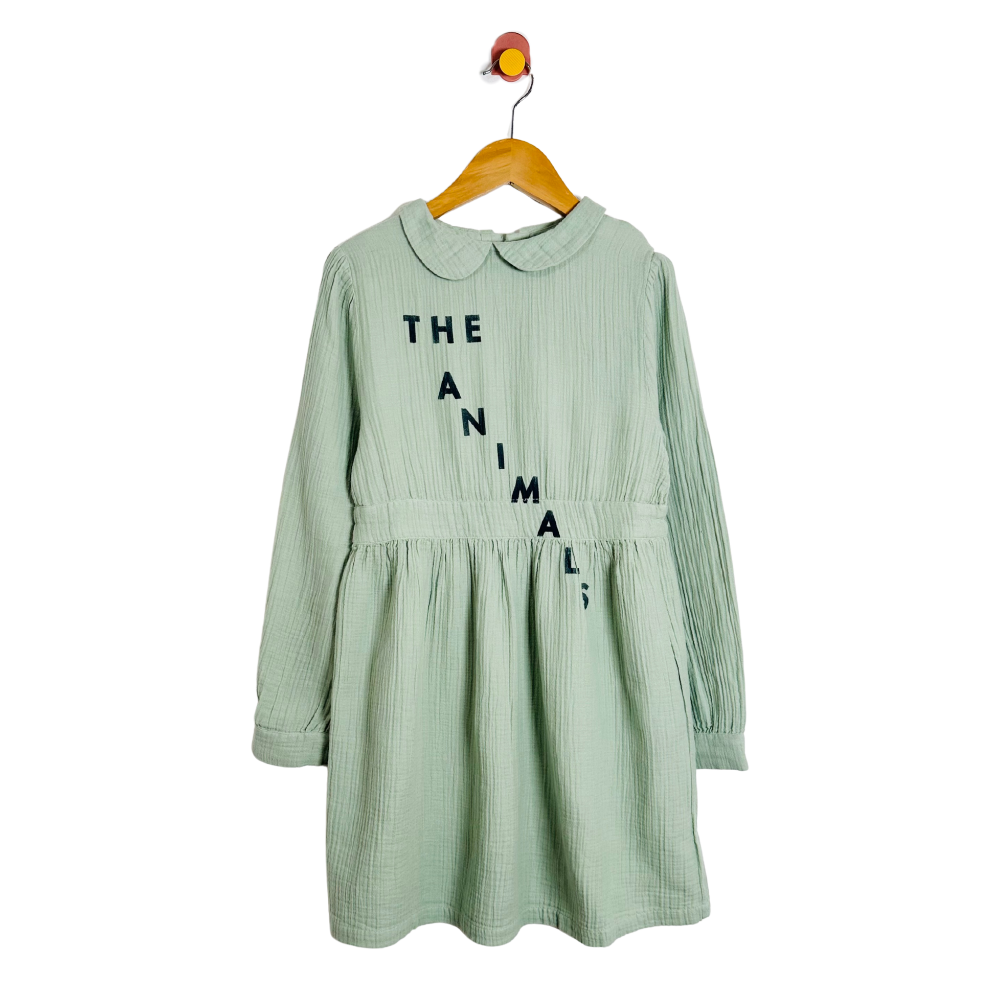 Green dress with text on a hanger against a white background