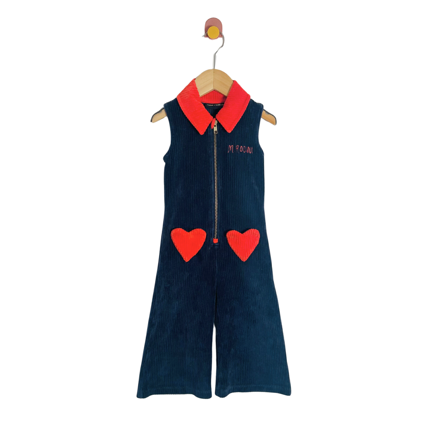 Children's navy blue jumpsuit with red hearts and collar on a hanger against a white background