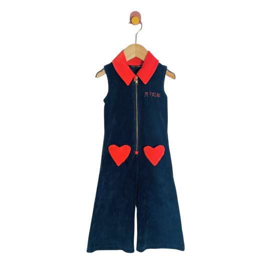 Children's navy blue jumpsuit with red hearts and collar on a hanger against a white background