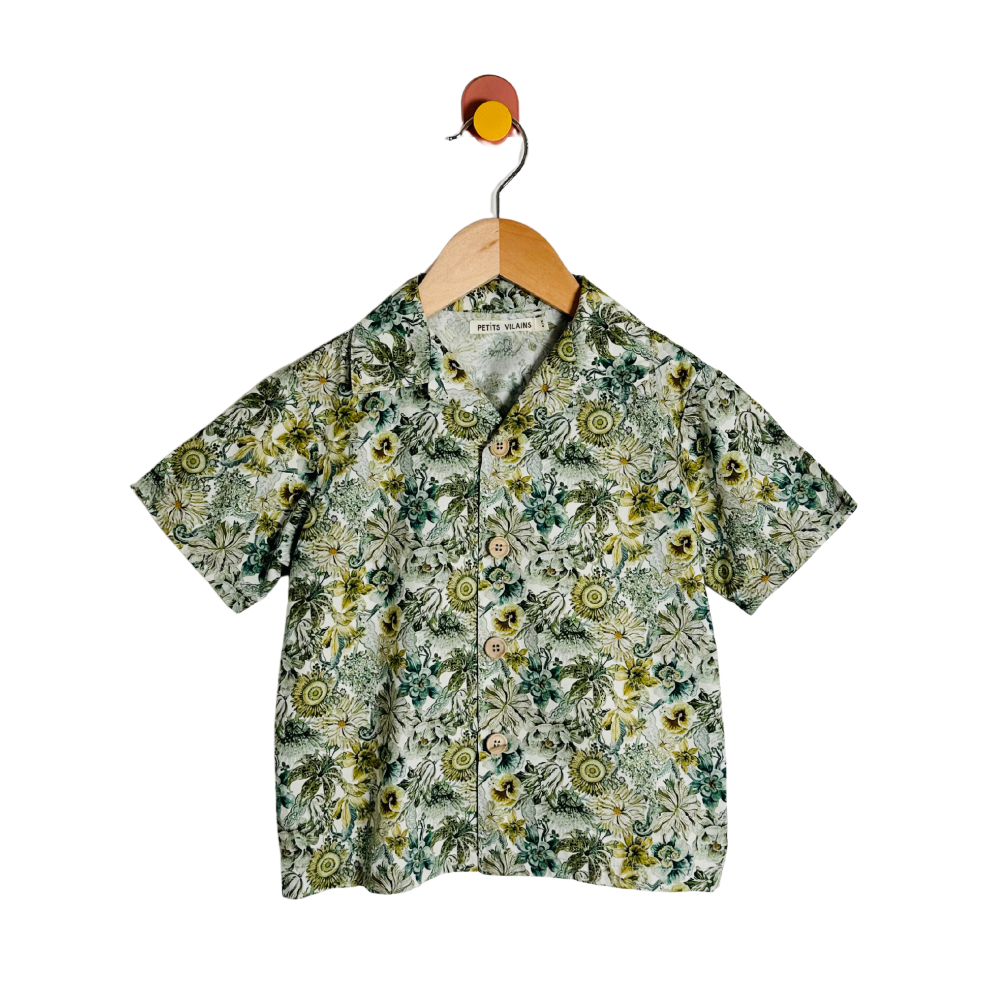 Floral patterned shirt on a hanger against a white background