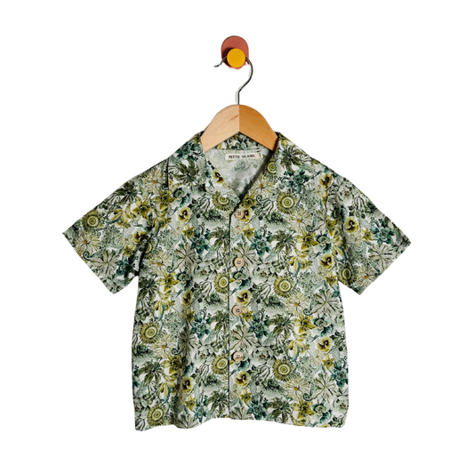 Floral patterned shirt on a hanger against a white background