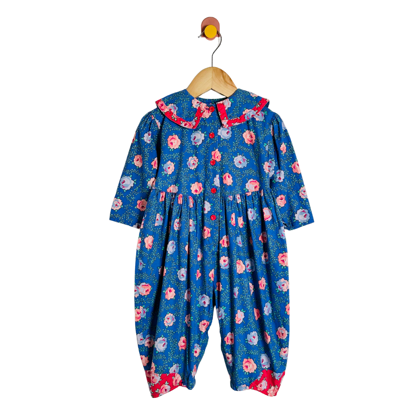 Floral-patterned baby romper on a hanger against a white background