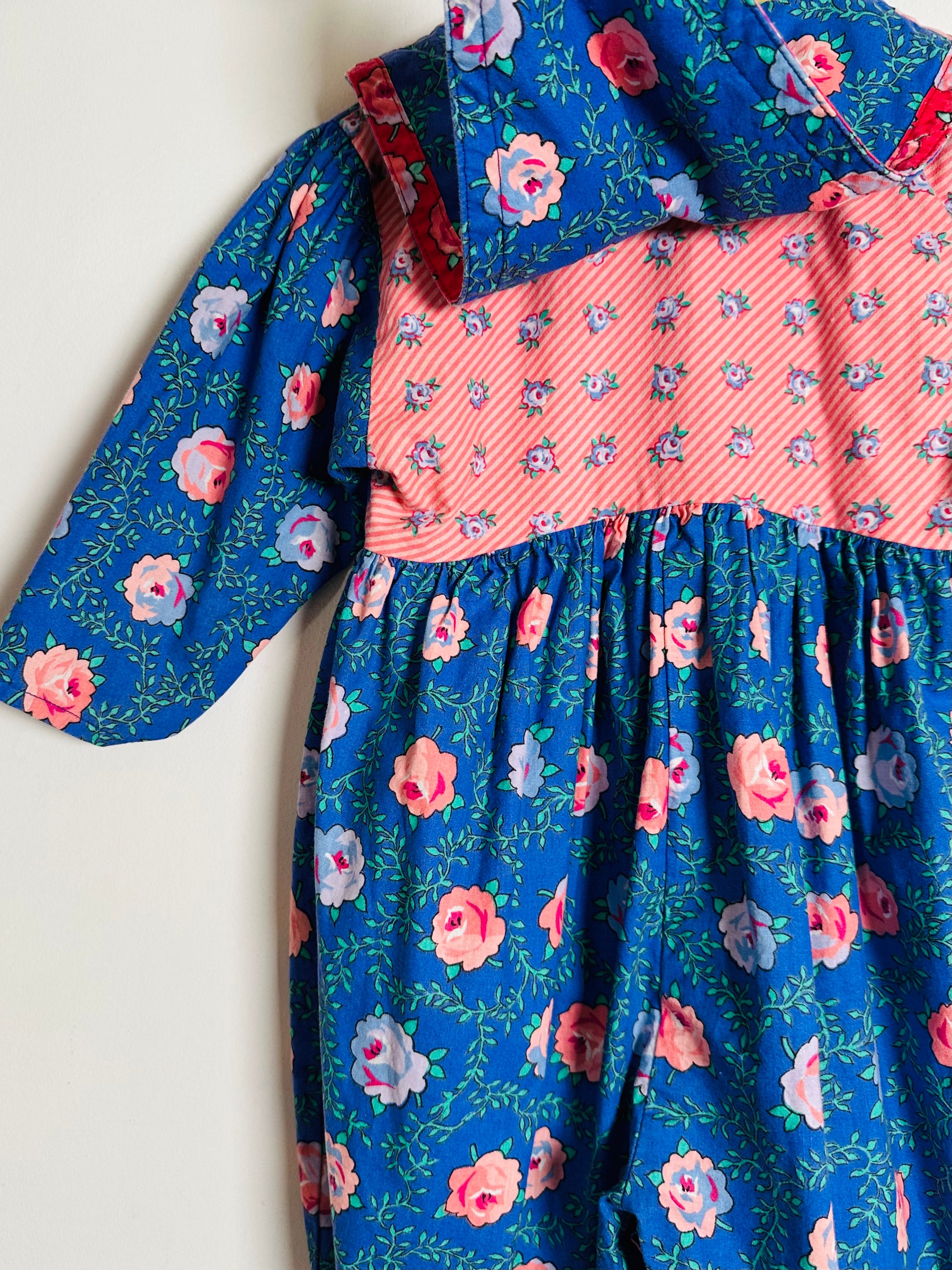 Children's romper with floral pattern on a white background