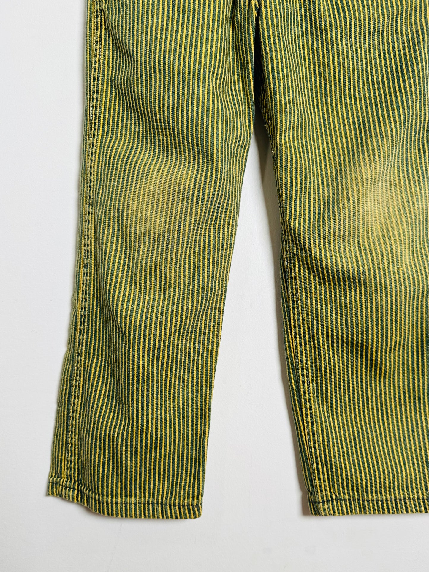 Green and yellow striped pants on a white background