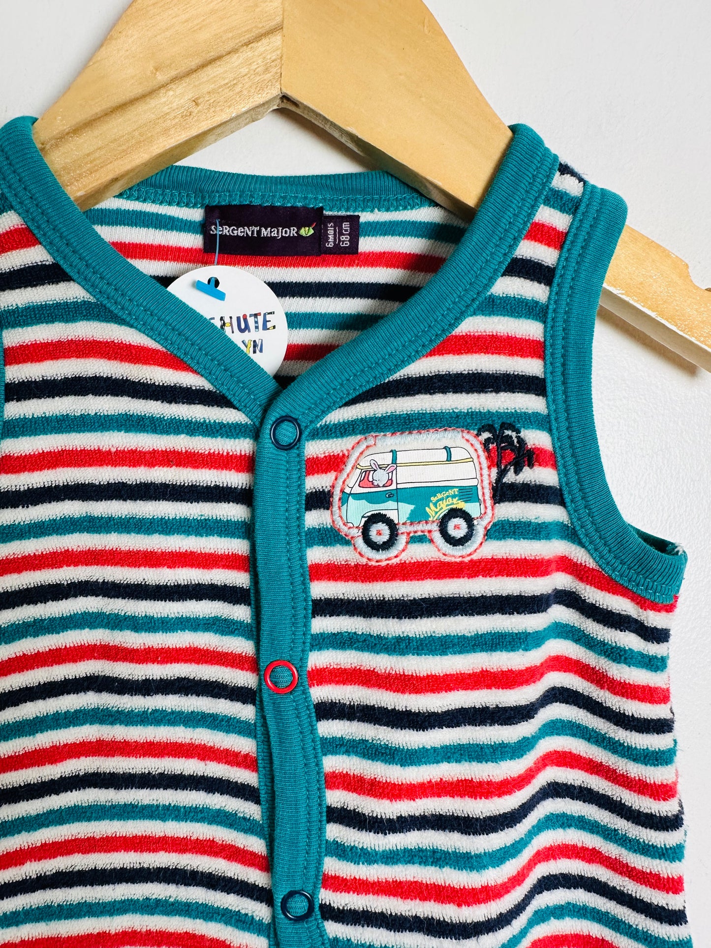 Striped baby romper with a car design on a hanger