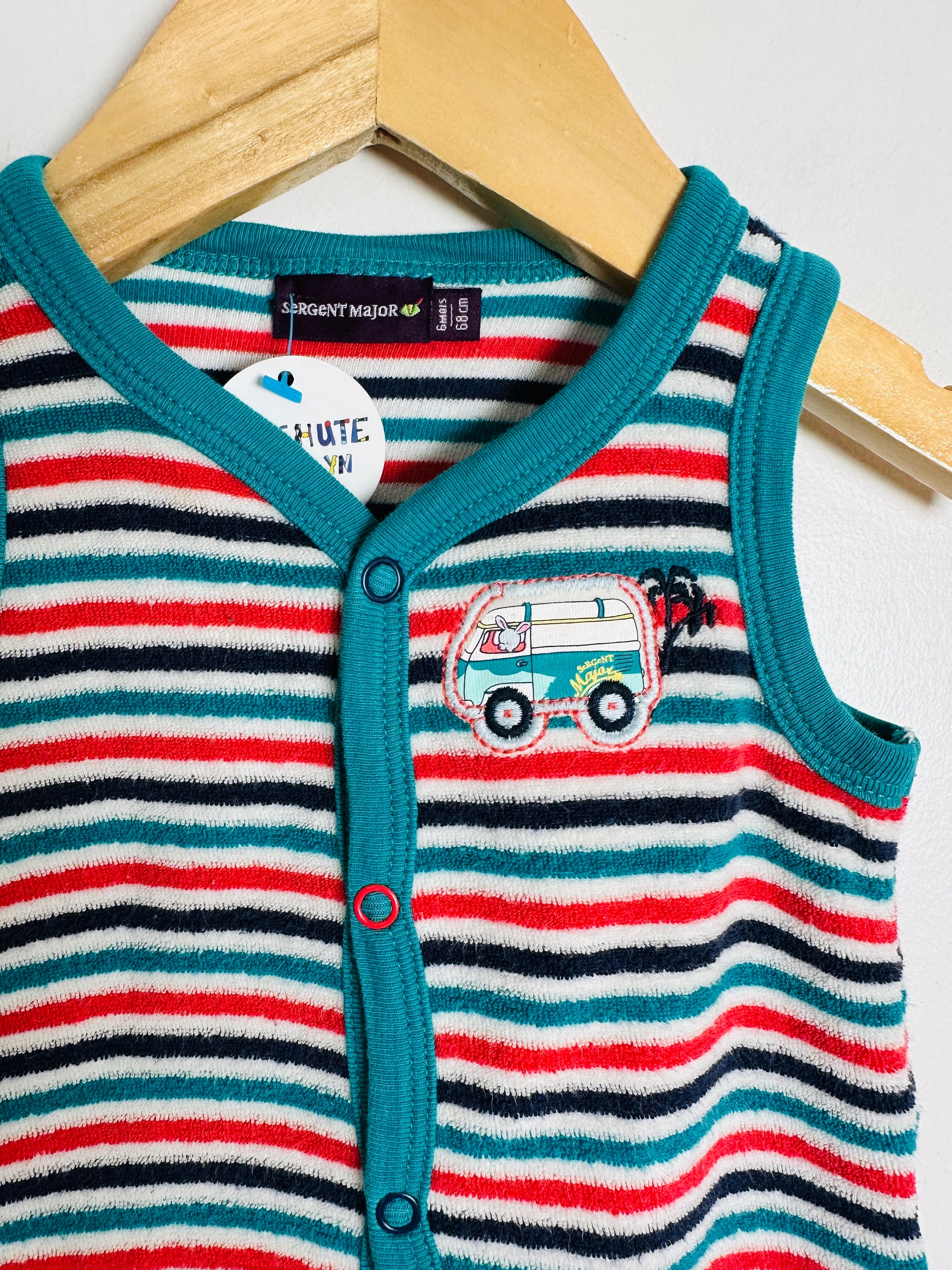 Striped baby romper with a car design on a hanger