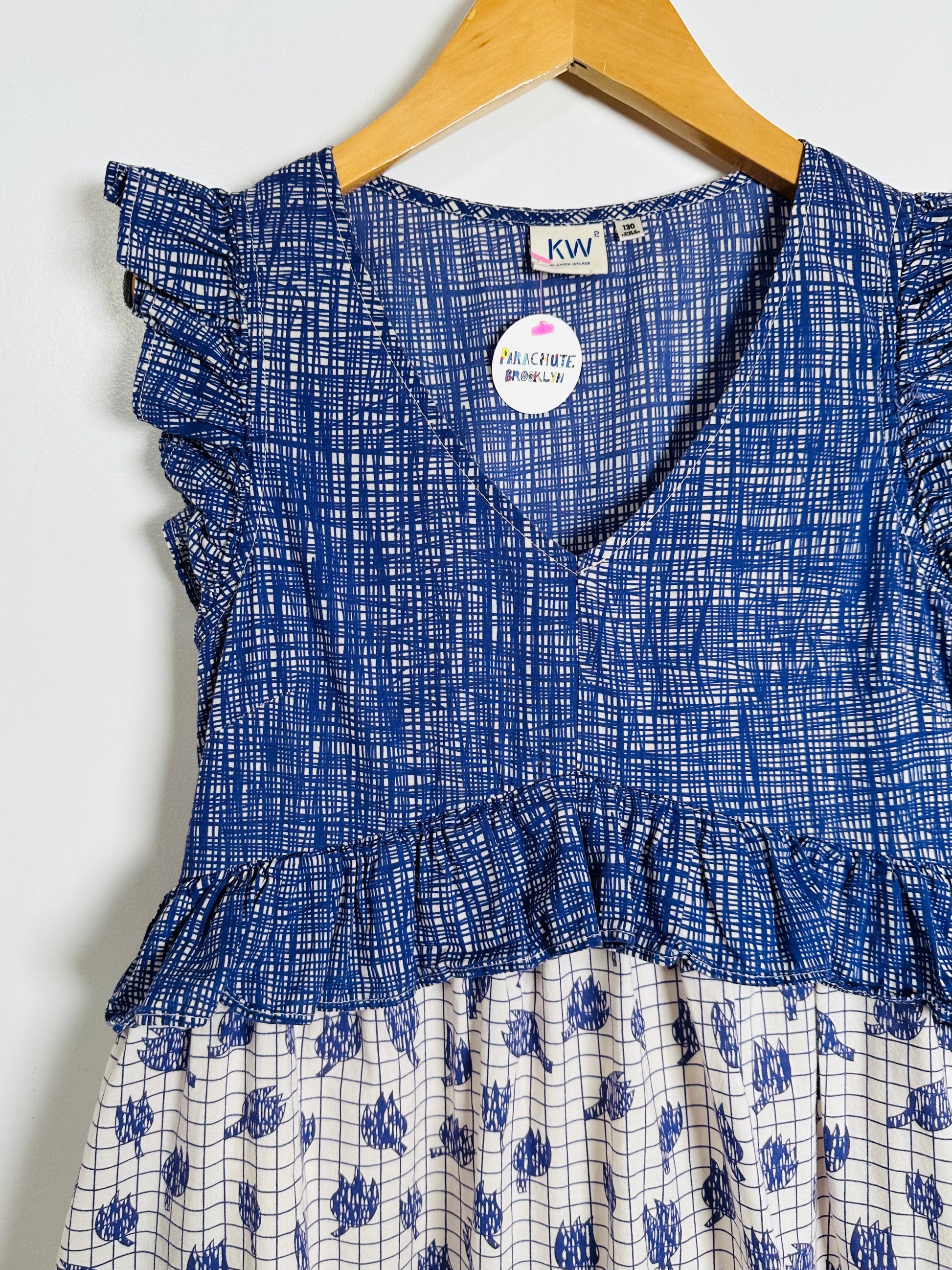 Blue and white patterned dress on a hanger with 'KW' label.
