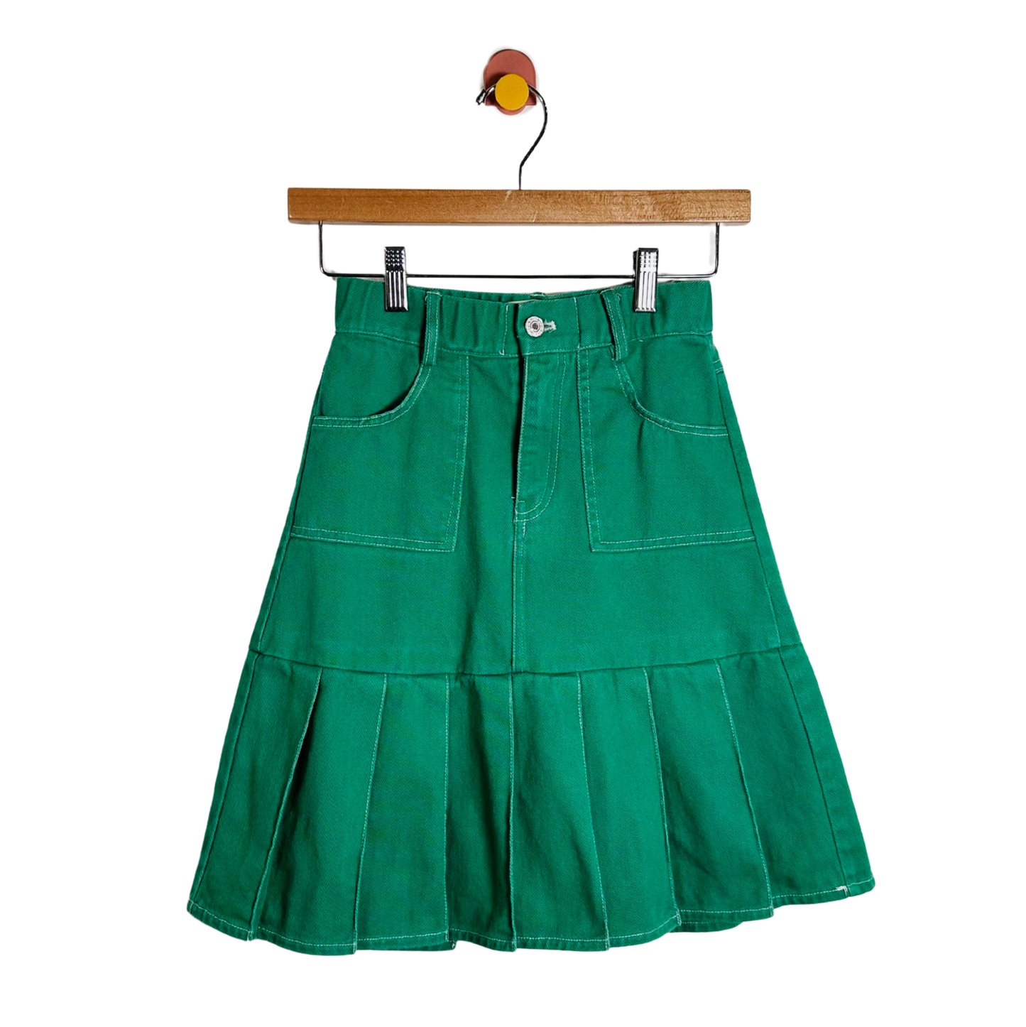 Green skirt on a hanger against a white background