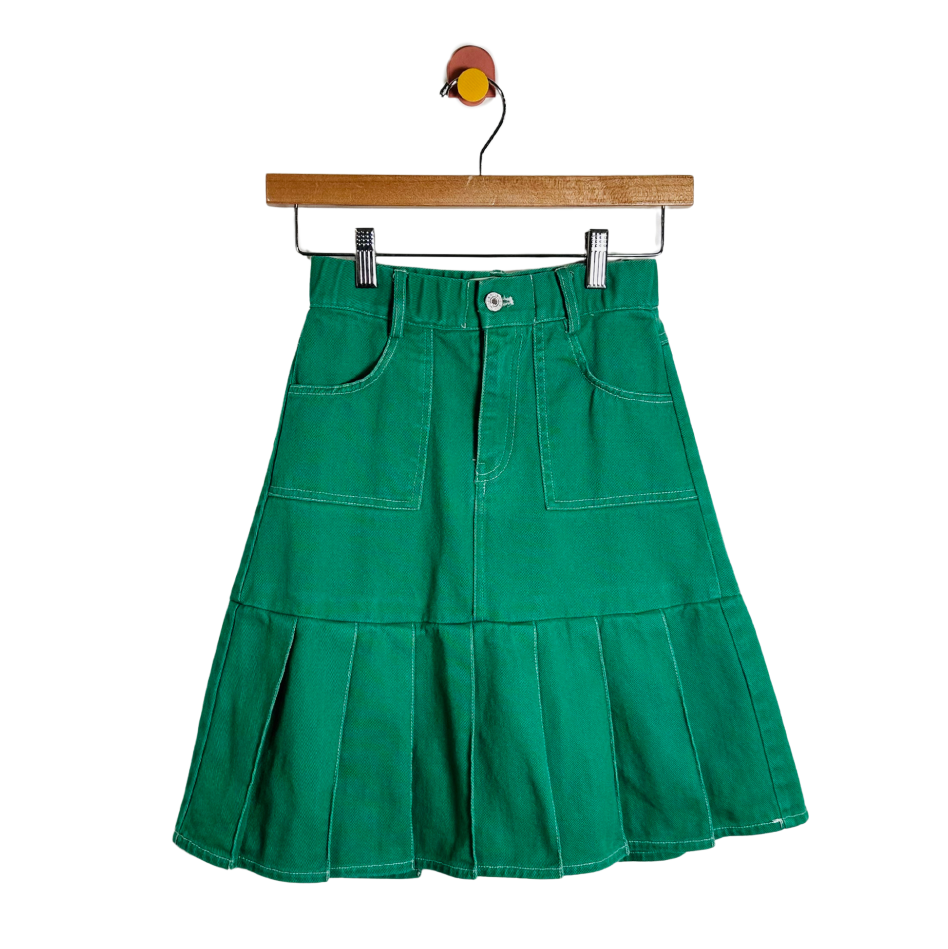 Green skirt on a hanger against a white background