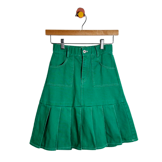 Green skirt on a hanger against a white background