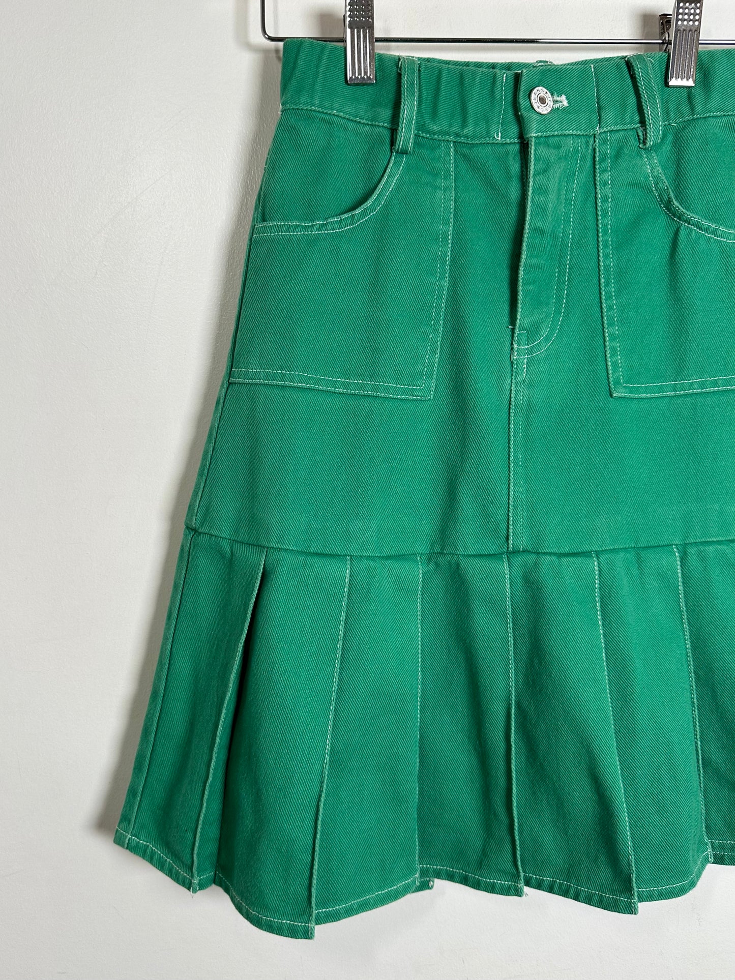 Green skirt with layered design on a white background
