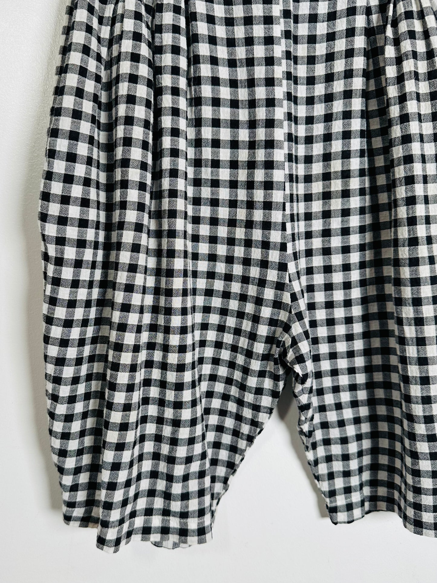 Black and white checkered pants on a light gray background